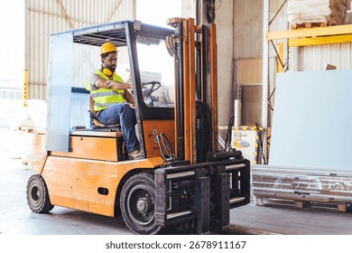 Worker operates a forklift inside a warehouse, unloading materials. He wears a hardhat and safety vest, displaying safe practices. The industrial setting reflects logistics and goods handling 