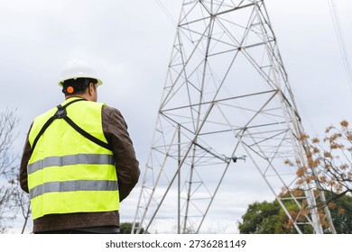 Worker operating a drone for infrastructure inspection, focusing on safety and technology