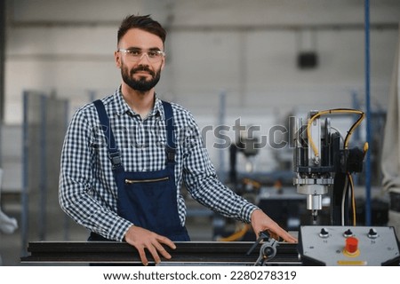 worker operating machine in factory.