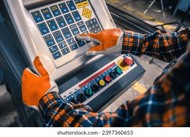 A worker operating a machine panel in a production plant. Modern factory. Machine operator.