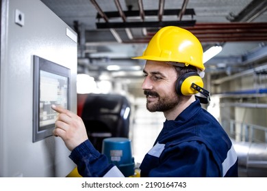 Worker operating modern industrial machine in production plant. - Shutterstock ID 2190164743
