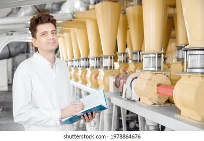 Worker Operator Checks Mill Production Line Of Cereals, Flour, Millet And Seeds. Food Industry Service Concept.