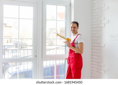 Worker In Overalls Setting Up New Windows In The Office