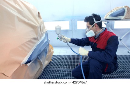 worker painting a car