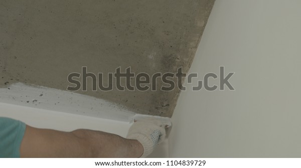 Worker Painting Concrete Ceiling Into White Stock Photo