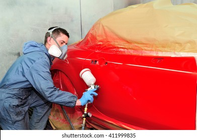 Worker Painting A Red Car.