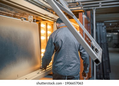 Worker Of The Painting Shop Checking Metal Products Near The Oven For Baking Powder Paint. Powder Coating Process At The Manufacturing. High Quality Photo