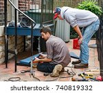 Worker Placing Bottom Step
