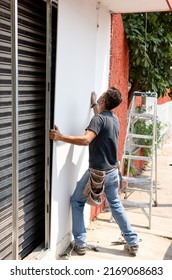 Worker Placing Drywall Sheets On Metal Structure