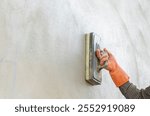 Worker polish wet motar with  Sponge trowel for smoothing plaster surface