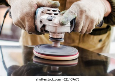 Worker Polishes A Stone With A Grinder