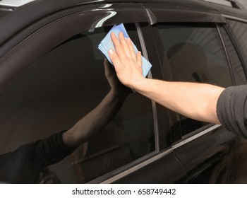 Worker Polishing Tinted Car Window