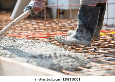 Worker Pouring Concrete Mix At Home Foundation