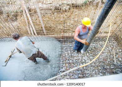 Worker Pouring Concrete Mix At Home Foundation