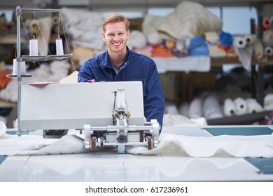 Worker In Protective Clothing In Factory Using Machine