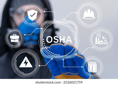 Worker in protective equipment using virtual touch screen presses acronym: OSHA. Occupational Safety and Health Administration ( OSHA ) concept. Worker safe environment regulation. OSHA regulations.