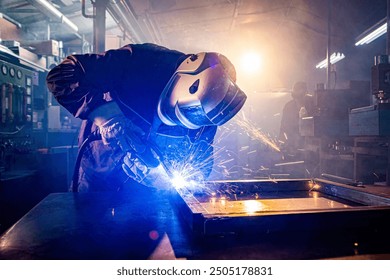 Worker with protective mask welding metal in workshop - Powered by Shutterstock