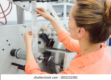 Worker at Quality control in the label printing shop