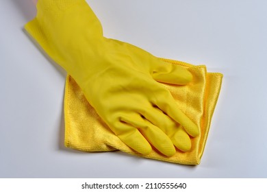 The Worker Removes Dust From The Furniture. Cleaning Service . A Hand In A Yellow Glove With A Dust Rag Close-up.