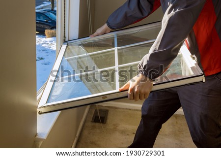 Worker in the removing break down windows in the home renovation living energy efficiency