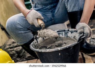 Worker Repair And Fix Cement Fence At Home. DIY Construction And Renovate House.