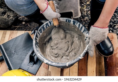 Worker Repair And Fix Cement Fence At Home. DIY Construction And Renovate House.