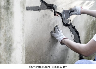 Worker Repair And Fix Cement Fence At Home. DIY Construction And Renovate House.