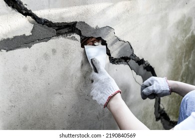 Worker Repair And Fix Cement Fence At Home. DIY Construction And Renovate House.