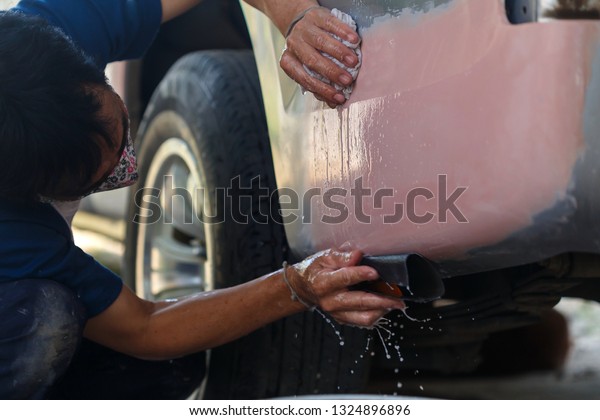 Worker repairing car body,Car paint repair,Car\
body worker welding car body\
blur.