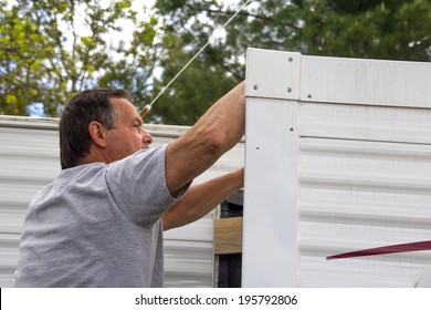 Worker Repairing Mobile Home