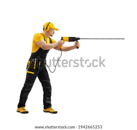 worker repairman or builder worked with construction tool - hammer drill percussion perforator , stand full body in black - yellow uniform on white background, isolated. Repair - construction concept 