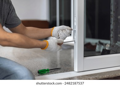 Worker replace aluminium swing door lock.