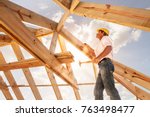  worker roofer builder working on roof structure on construction site