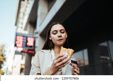 Worker Rushes To Work And Eats On The Go, Drinks Coffee In The Street