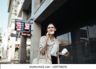 Worker Rushes To Work And Eats On The Go, Drinks Coffee In The Street