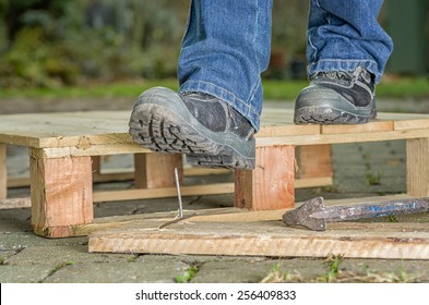 Worker With Safety Boots Steps On A Nail