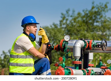 Worker with safety equipment on oil plant