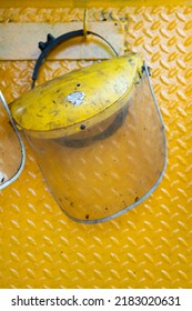 A Worker Safety Face Shield Is Keeping On Storage Rack.  Industrial Safety Equipment Photo. Close-up And Selective Focus, 