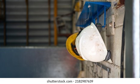 A Worker Safety Hardhat Or Helmet Is Keeping On Storage Rack.  Industrial Equipment Photo. Close-up And Selective Focus, 