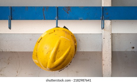 A Worker Safety Hardhat Or Helmet Is Keeping On Storage Rack.  Industrial Equipment Photo. Close-up And Selective Focus, 