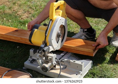 A Worker Saw Wood With A Chop Saw