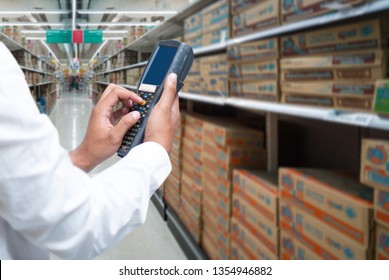 A worker scanning cargo with bluetooth barcode scan. Reading and scanning barcode on the cargo in a warehouse.