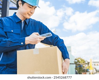 A worker scans the label on a package with his smartphone - Powered by Shutterstock