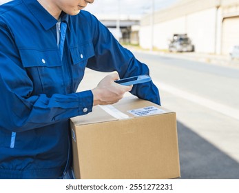 A worker scans the label on a package with his smartphone - Powered by Shutterstock