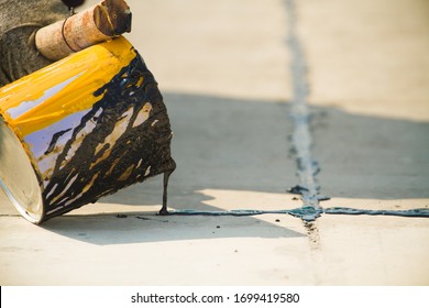 Worker Sealing Asphaltic Joint For Construction Joint On Concrete Pavement, Filling Expansion Joint Concrete Pavement.