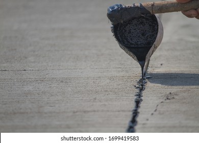 Worker Sealing Asphaltic Joint For Construction Joint On Concrete Pavement, Filling Expansion Joint Concrete Pavement.