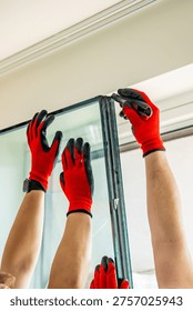 Worker separating triple glazed window glass unit into individual panels for safe handling and disposal after damage in apartment. Window repair, glass recycling and maintenance process concept
