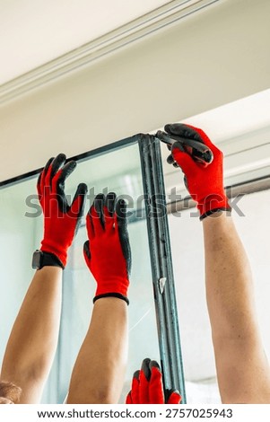 Worker separating triple glazed window glass unit into individual panels for safe handling and disposal after damage in apartment. Window repair, glass recycling and maintenance process concept