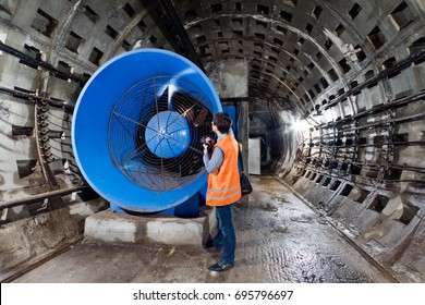 Worker Serves Big Industrial Ventilation Fan In The Subway Tunnel