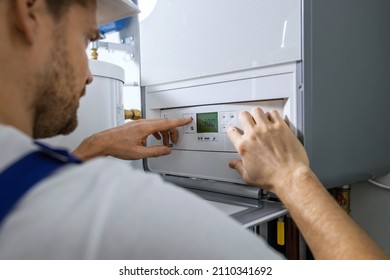 Worker Set Up New Central Gas Heating Boiler For Home